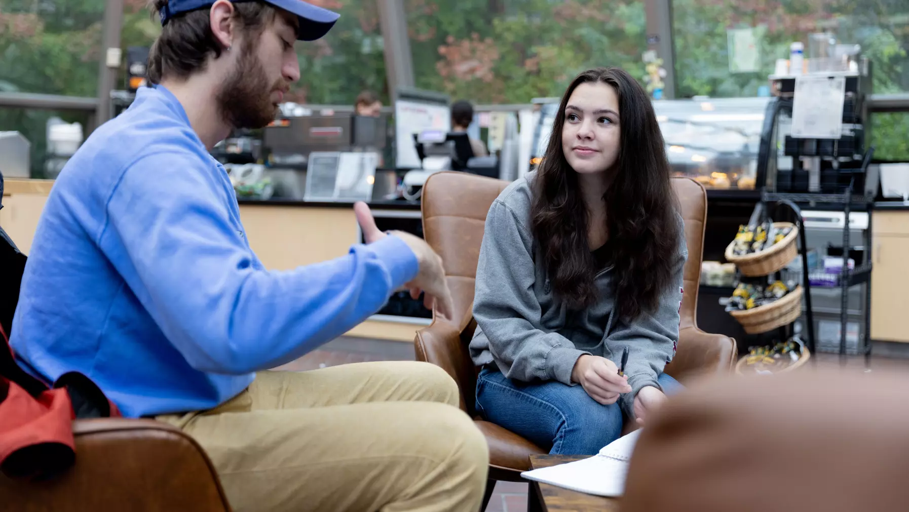 Older UPS student advises younger UPS student in Oppenheimer cafe