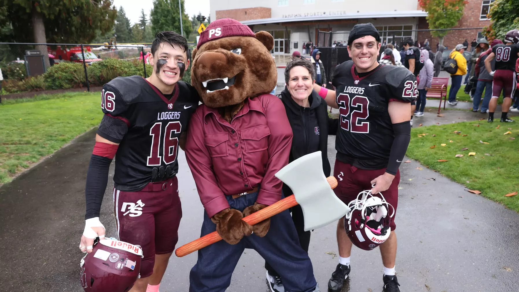 Grizz with Athletic Director Chelsea Herman (center), Isaac Tran ’27 (left), and Julian Quigley ’26 (right).