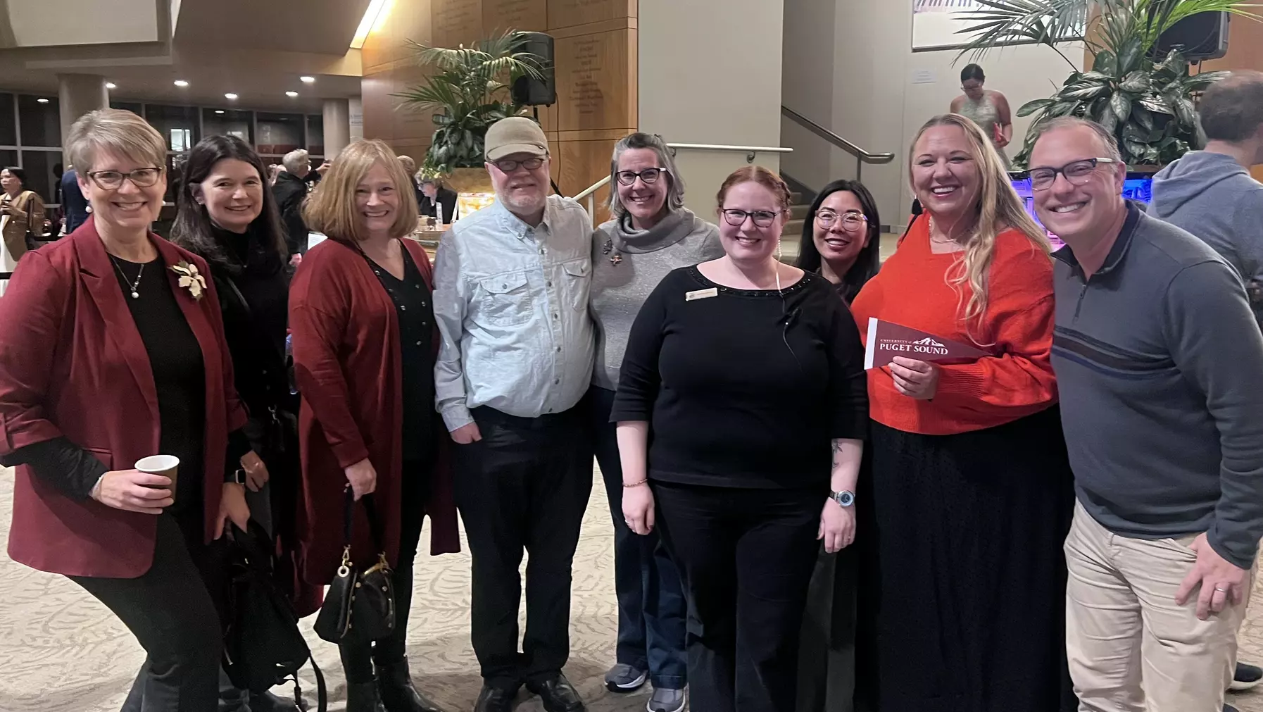 Alumni taking picture together smiling