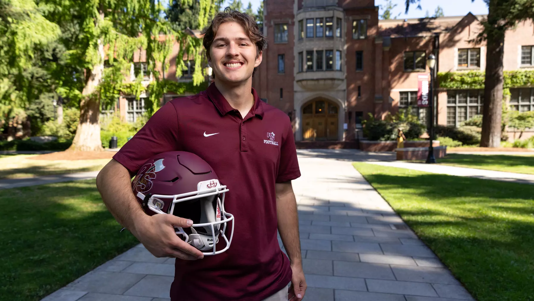 Jake Elorduy ’26 on campus with his football helmet.