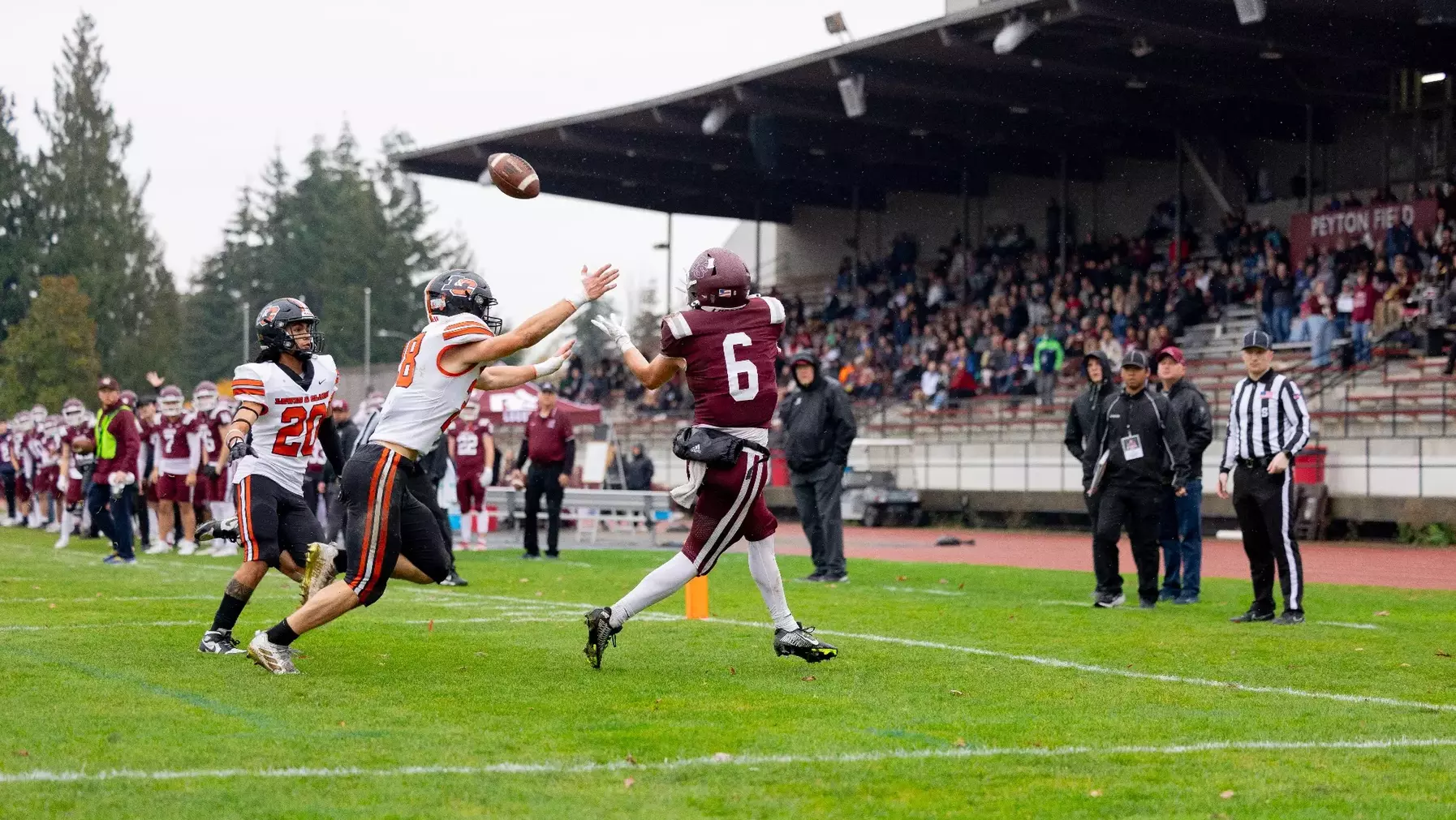 Elorduy (wearing jersey No. 6) catches a pass during a football game.