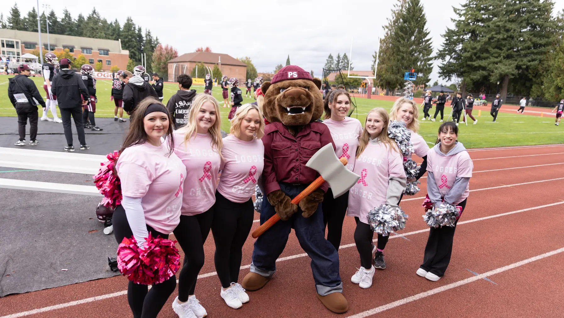 Grizz with the Cheer team at the Homecoming Football Game