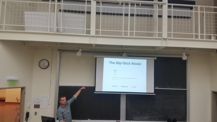 A person pointing at a projector screen.