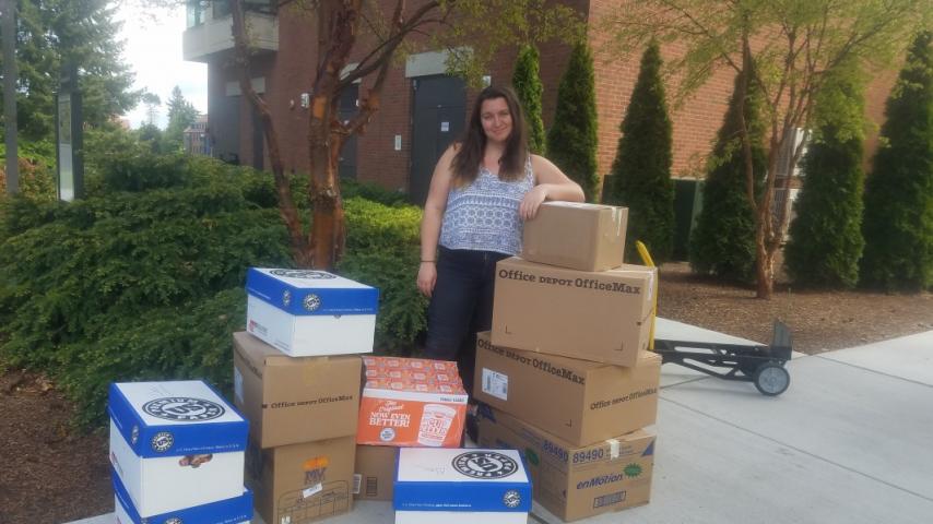 A person standing in front of some boxes.