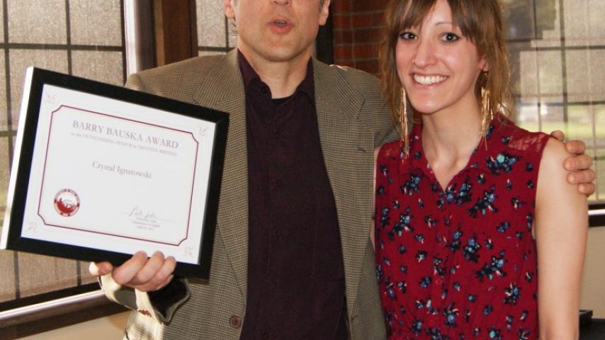 Two people with an award.