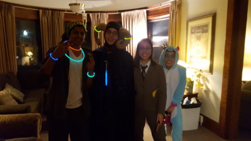 Four people standing together wearing costumes.