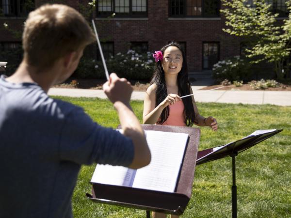 A group of students rehearse and practice conducting before the annual Pops On the Lawn summer concert in Karlen Quad