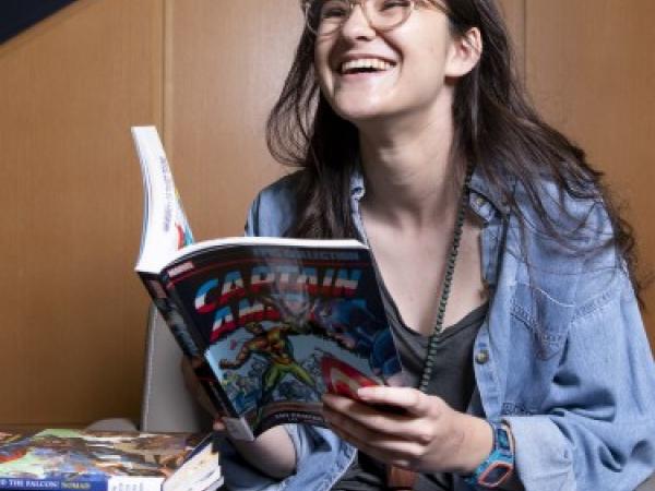 laughing student reading a book