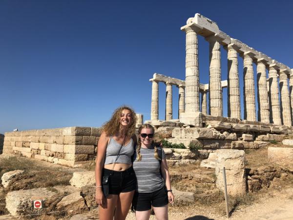Students with ancient building ruins