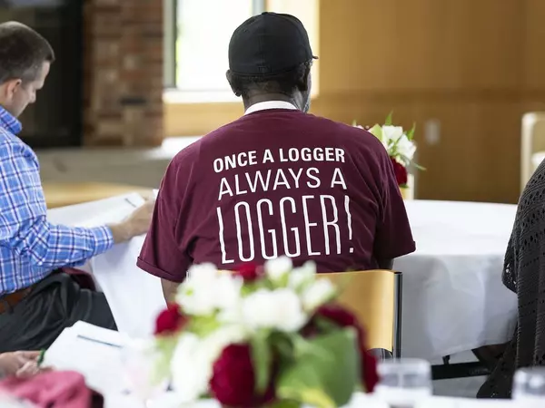Alum wearing a Once a Logger, Always a Logger T-shirt