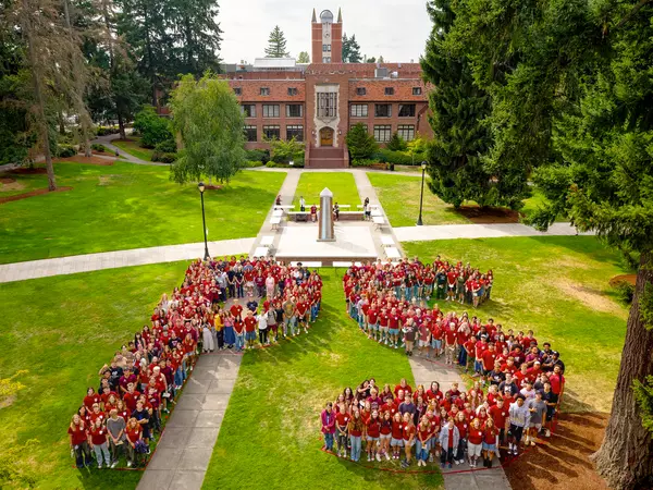 Aerial image of students on a field grouped into the shape of the letters PS.