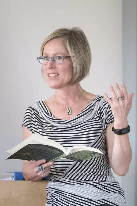 Monica DeHart reads from a book