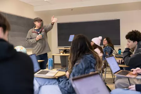 Prof. Neshyba speaks in front of a class