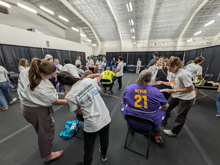 FUNfitness clinic room filled with volunteers assisting athletes. 