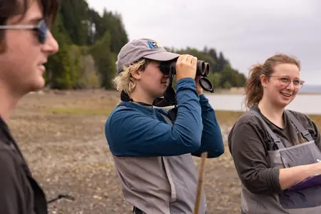 Bea Moldow looks through binoculars 