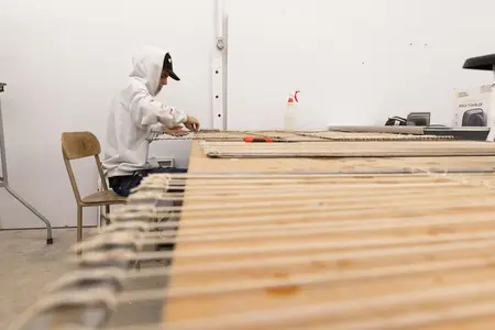 Roy Kersten-Hellikson ’27 weaving on metal frames