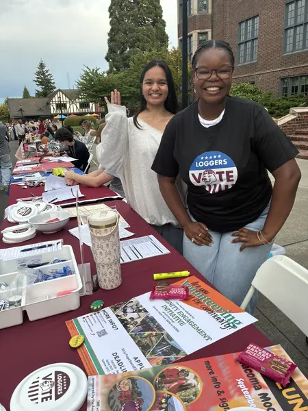 Grace and Olivia pose for a photo while tabling at a campus event.