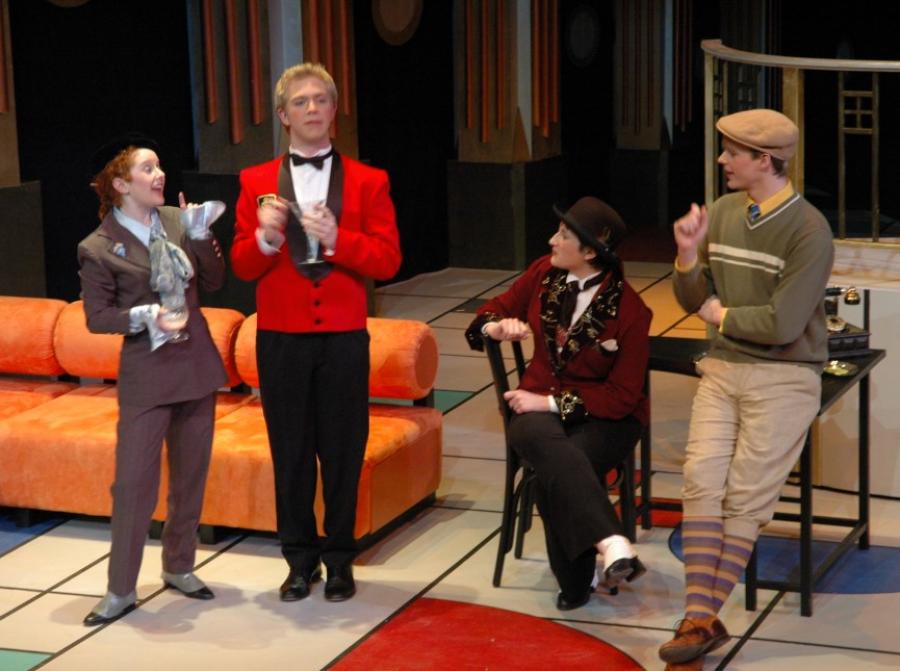 Four actors on a stage in a play