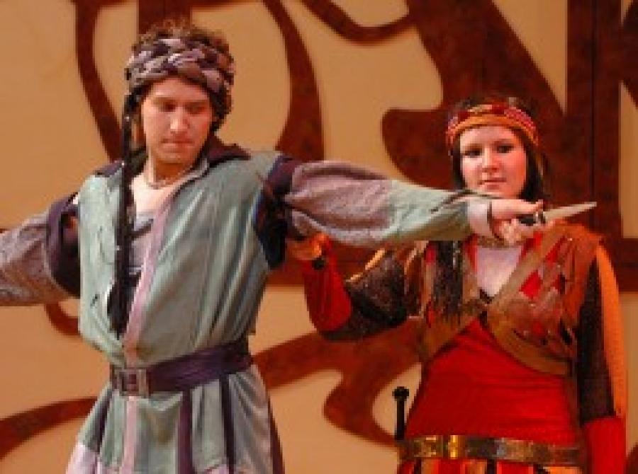 Male and Female actors in costume on stage