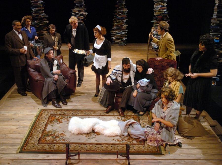 Actors gather around something on a rug