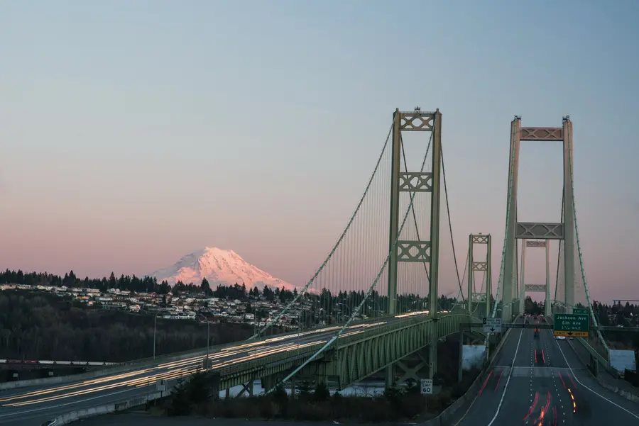 Mount Rainier towers over Tacoma from the west side of the Tacoma Narrows bridge.